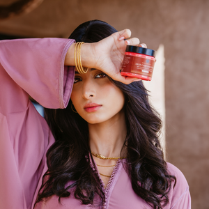 Model showcasing Aker Fassi Sabounia with Moroccan argan oil, a natural product for evening skin care and softening.