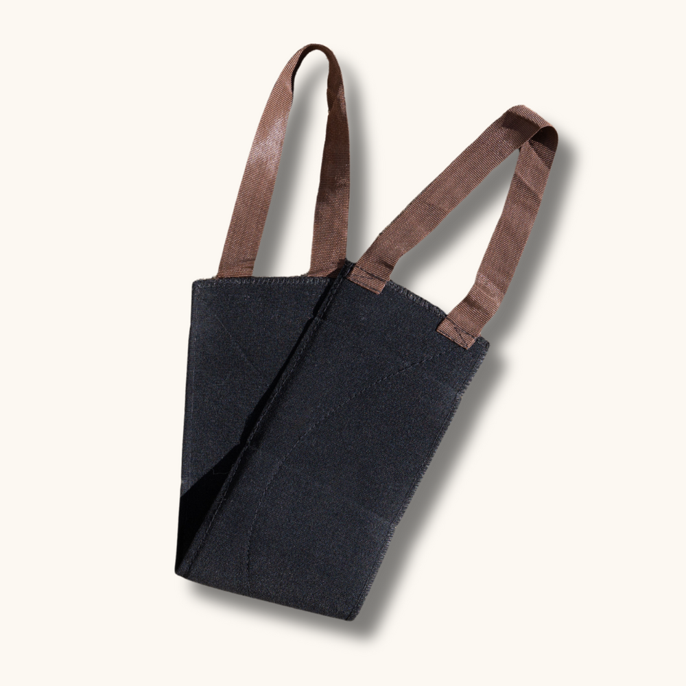 Exfoliating back scrubber from Skalli Essentials, featuring a black fabric design with brown straps, designed for effective back acne treatment.