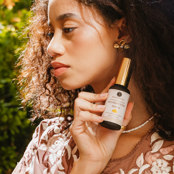 Close-up of Frankincense serum being applied to the skin, featuring a lightweight formula with Hyaluronic Acid and Vitamin C for deep hydration and nourishment.