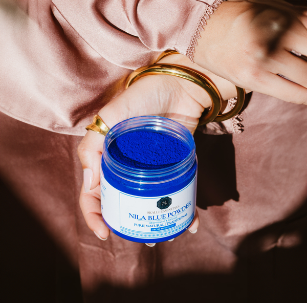 Skalli Essentials Nila Blue Powder  applied to the skin, gently exfoliating and brightening the complexion with organic Moroccan ingredients.