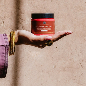 Aker Fassi Sabounia with Moroccan argan oil, perfect for cleansing, evening care, and softening your skin, as held by a model.