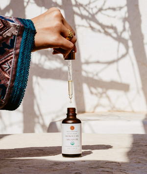 Close-up of Skalli Essentials Argan Oil dropper bottle, ideal for nourishing and hydrating skin and hair with organic Moroccan Argan Oil.