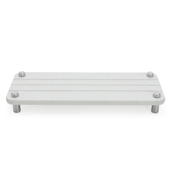 Skalli Essentials white bathroom organizer shelf with stainless steel legs, perfect for placing toiletries or small accessories in a modern bathroom setting.