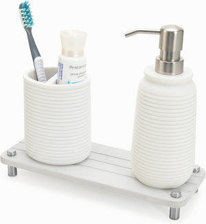 Skalli Essentials white bathroom organizer shelf with a toothbrush holder and soap dispenser, providing a minimalist and functional design for the countertop.