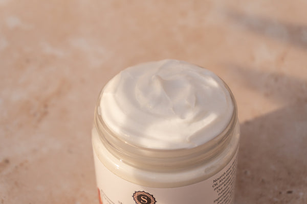 Skalli Essentials Nila & Argan Mask with a spatula, showcasing its natural exfoliating formula for a brighter, smoother complexion.